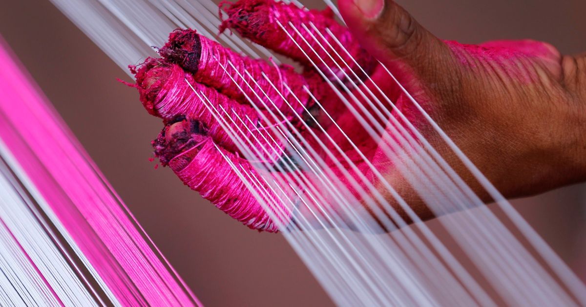 Працівник використовує кольорові рядки, які будуть використовуватис для виготовлення повітряних зміїв в Ахмадабаді, Індія. / © Reuters