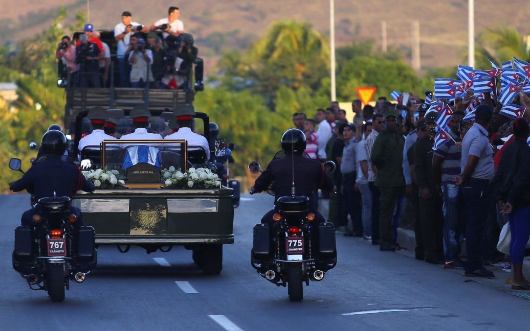 Прах Кастро до кладбища везли на автомобиле в кедровой урне. Люди скандировали "Вива, Фидель!" / © Reuters