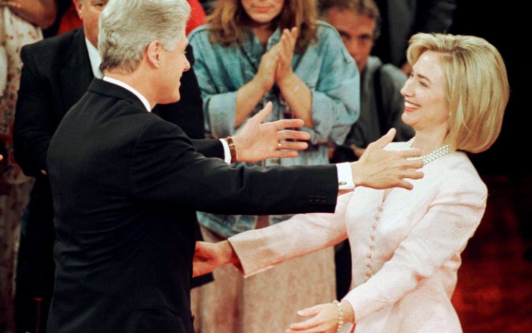 Президент Билл Клинтон протягивает руку, чтобы обнять свою жену Хиллари после его дебатов с кандидатом в президенты республиканцем Бобом Доулом в Сан-Диего, Калифорния, США, 16 октября 1996 года. / © Reuters