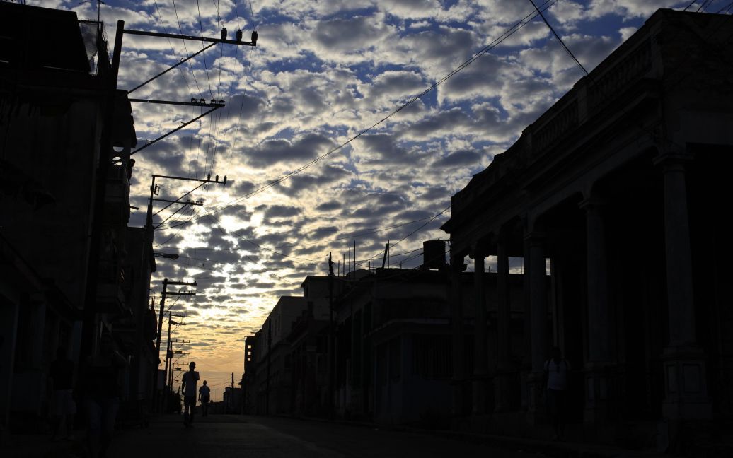 Люди йдуть по вулиці під час світанку в Гавані, Куба. / © Reuters
