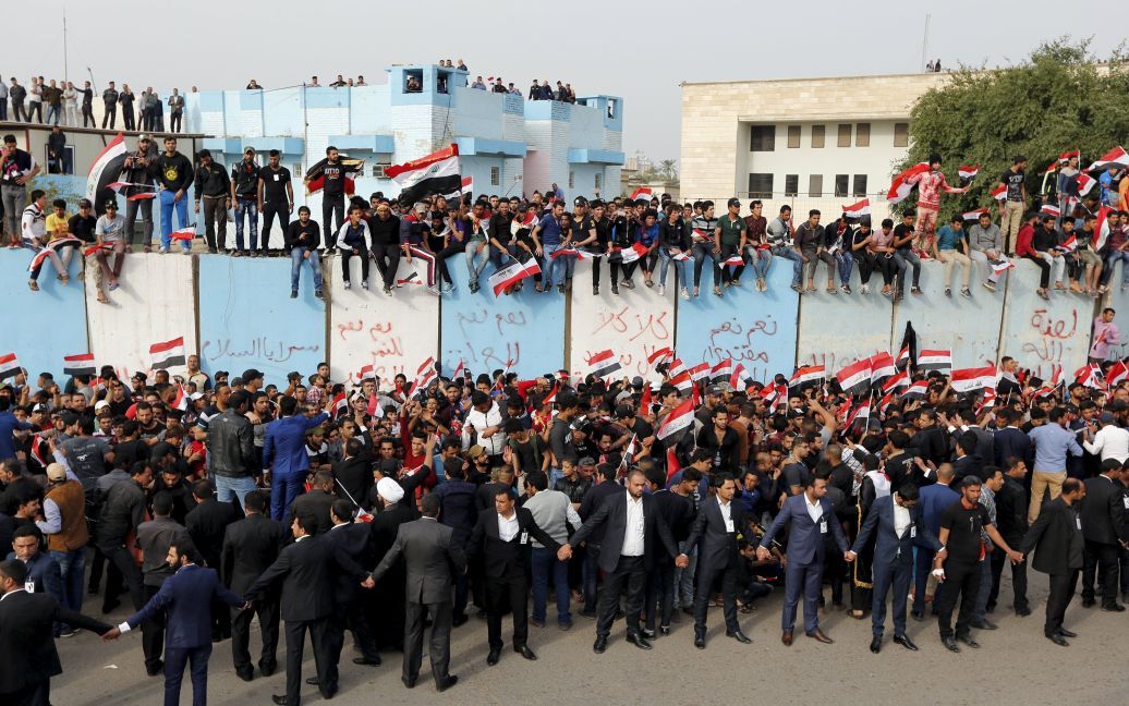 Сторонники выдающегося иракского шиитского священнослужителя Муктады ас-Садра выкрикивают лозунги во время акции протеста против коррупции во власти за пределами Зеленой зоны в Багдаде, Ирак. / © Reuters