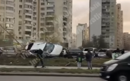 У Києві водій таксі вилетів з дороги, перекинувся і влетів у припарковані автівки: відео