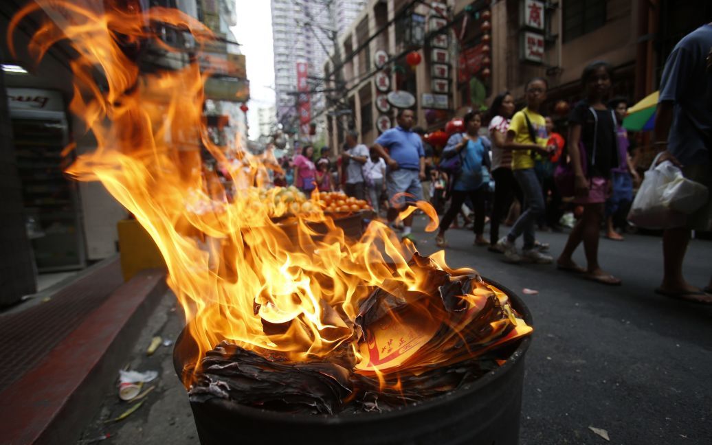 Филиппины, Манила. Одной из традиций является сжигание бумажных денег / © Reuters