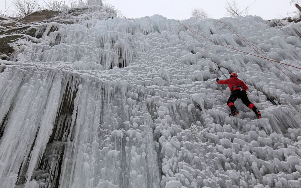 Человек поднимается по искусственной ледовой стене в городе Либерец, Чехия. / © Reuters